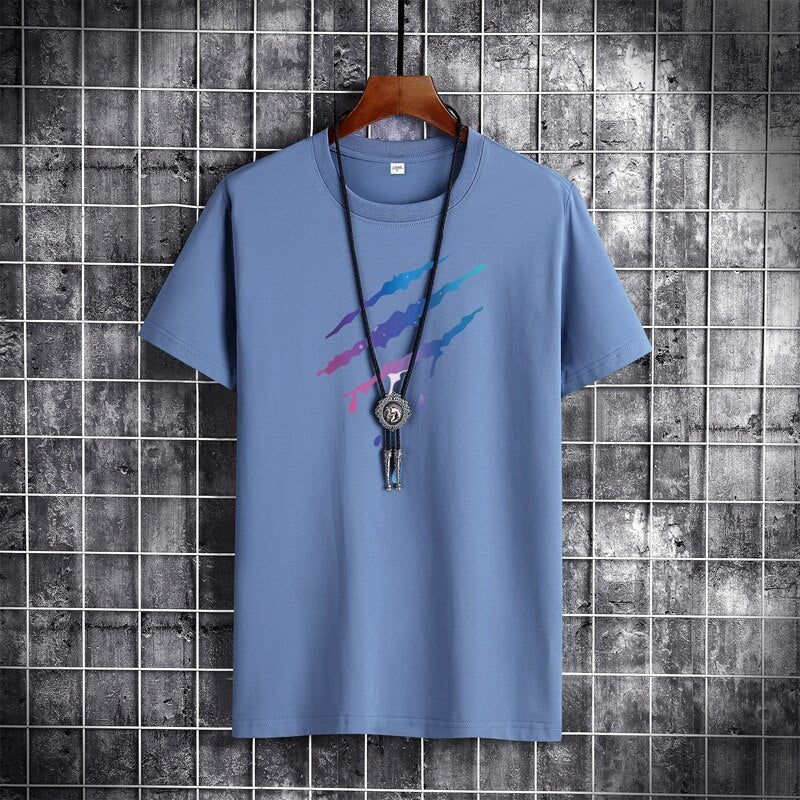 Men's blue short-sleeve cotton t-shirt with necklace accessories on hanger against tiled background.