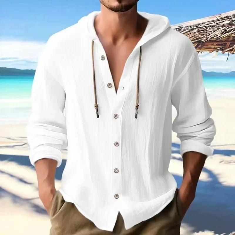 Men's casual white linen long sleeve hoodie shirt on a beach setting.