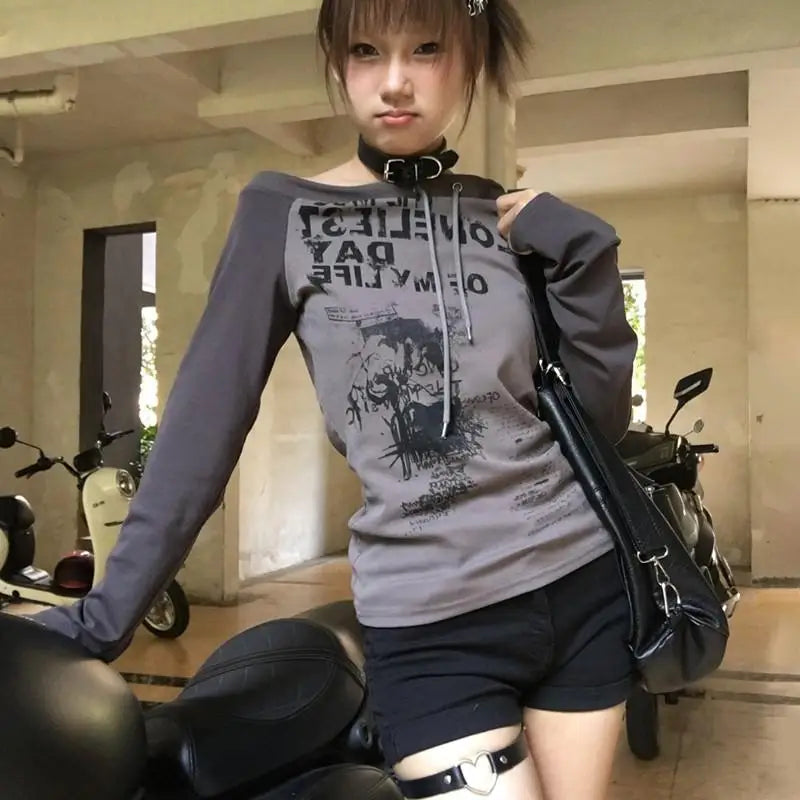 Japanese Y2k off-shoulder long sleeve T-shirt with grunge graffiti print, Harajuku streetwear style.