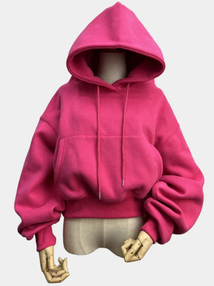 Women's fleece hoodie in solid pink, casual tracksuit style, perfect for winter and spring sportswear.