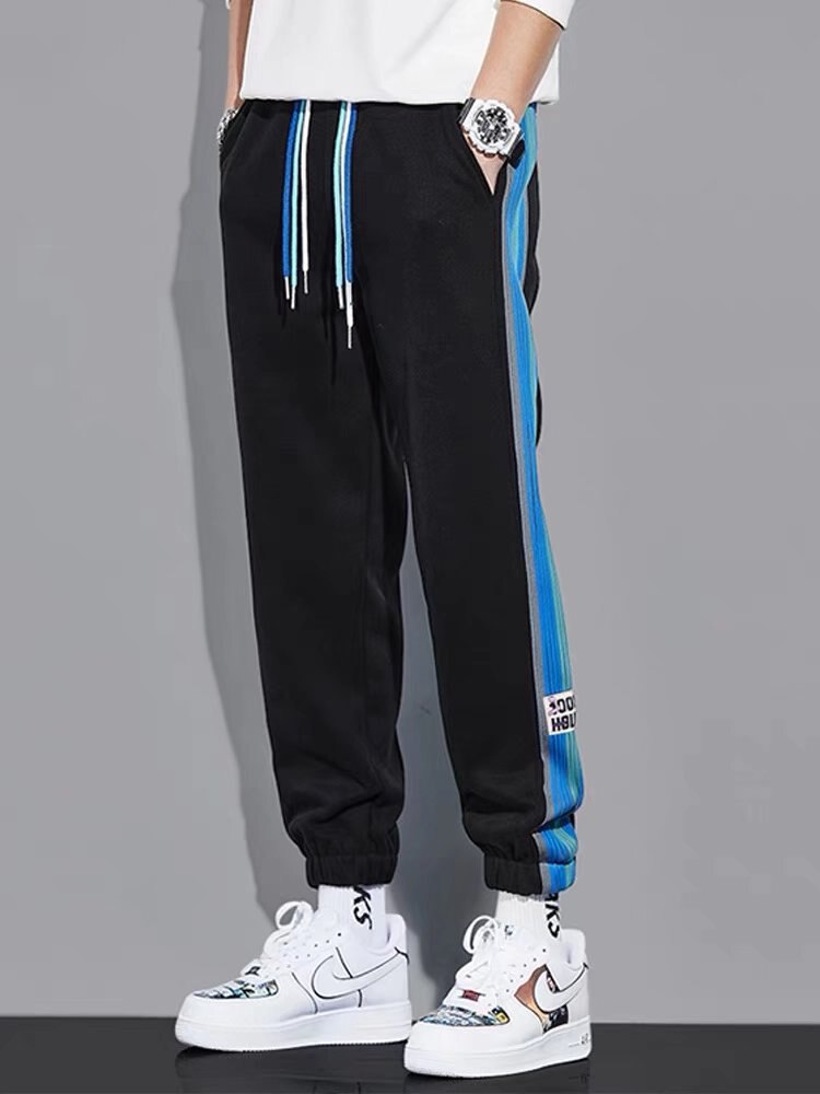 URSPORTTECH hip hop techwear joggers, black with blue stripes, elastic waist, streetwear cargo pants for men.