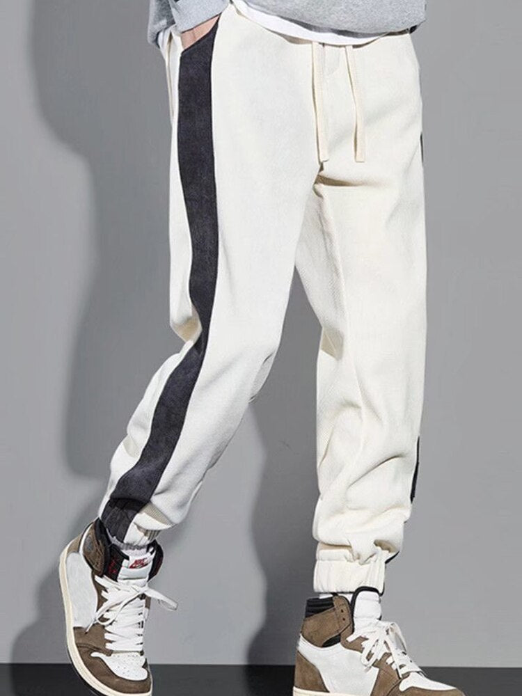 White and black URSPORTTECH joggers pants featuring elastic waist and drawstring closure, ideal for hip hop streetwear style.