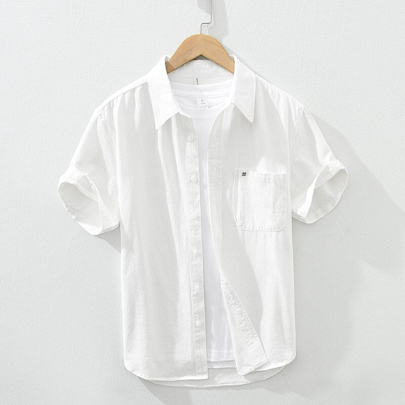 Men's white short sleeve cotton shirt with patch pocket and embroidery, casual summer top.