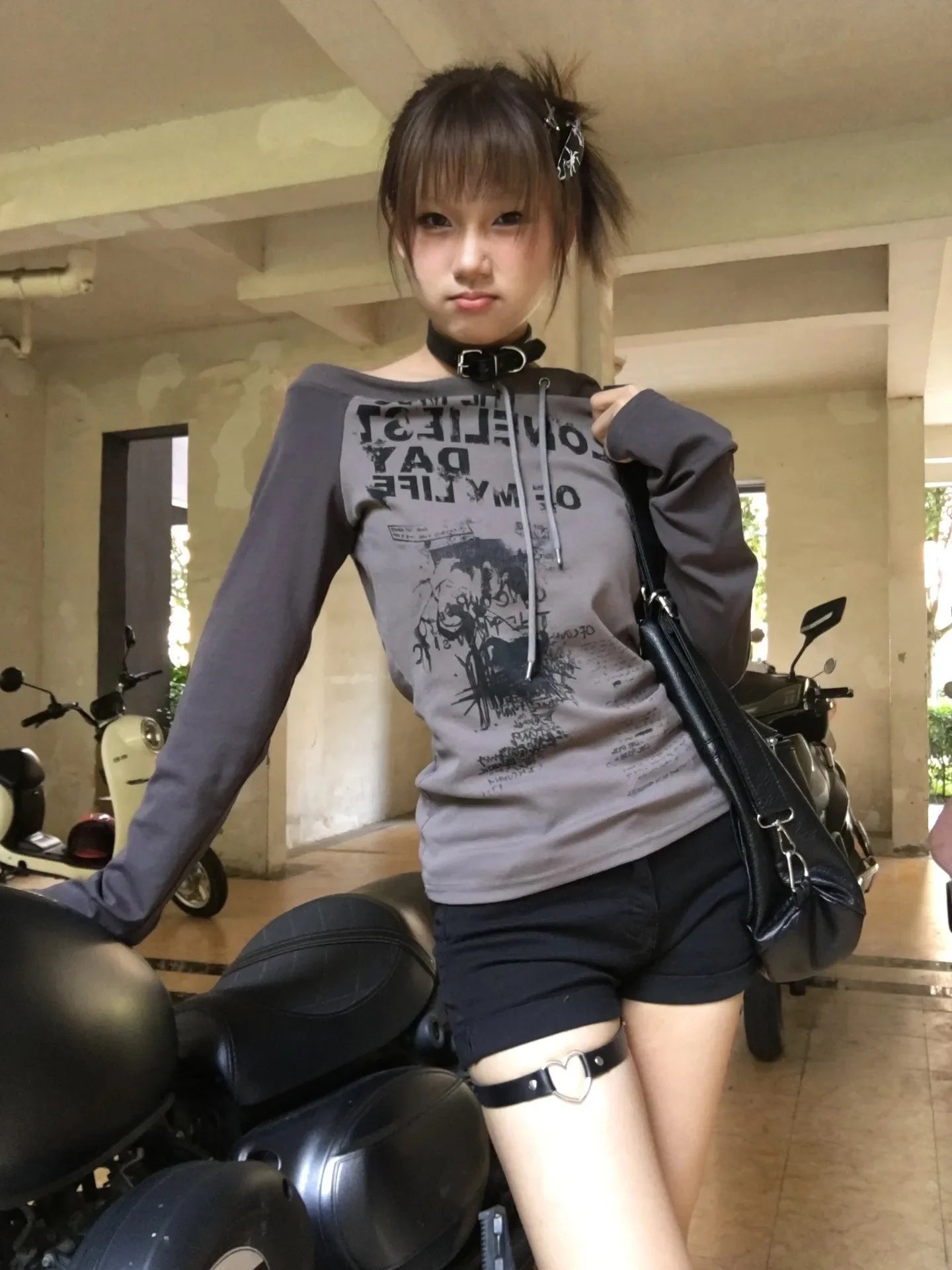 Off-shoulder grunge graffiti print long sleeve tee shirt in vintage Harajuku style.