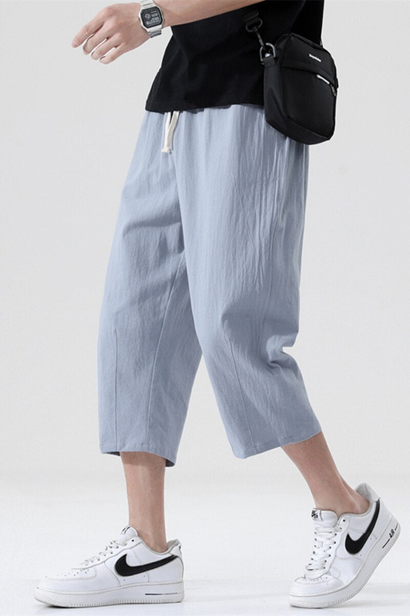 Men's summer casual loose linen pants in Korean style, nine-point length, mid-waist, solid pattern, drawstring closure, suitable for daily wear.