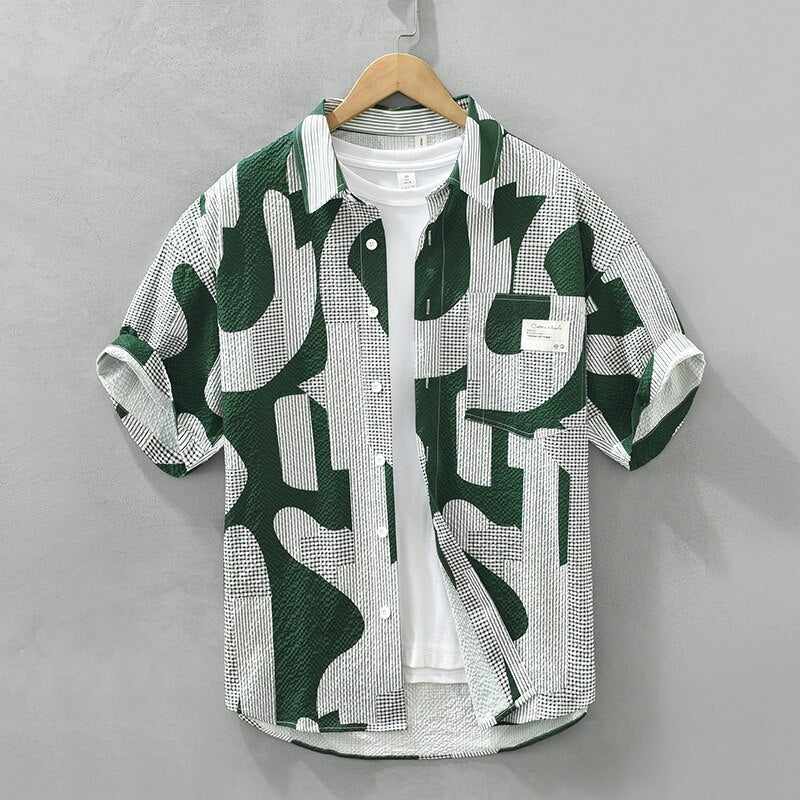 Men's green and blue print short sleeve shirt, loose casual summer streetwear, thin breathable cotton, displayed on hanger.