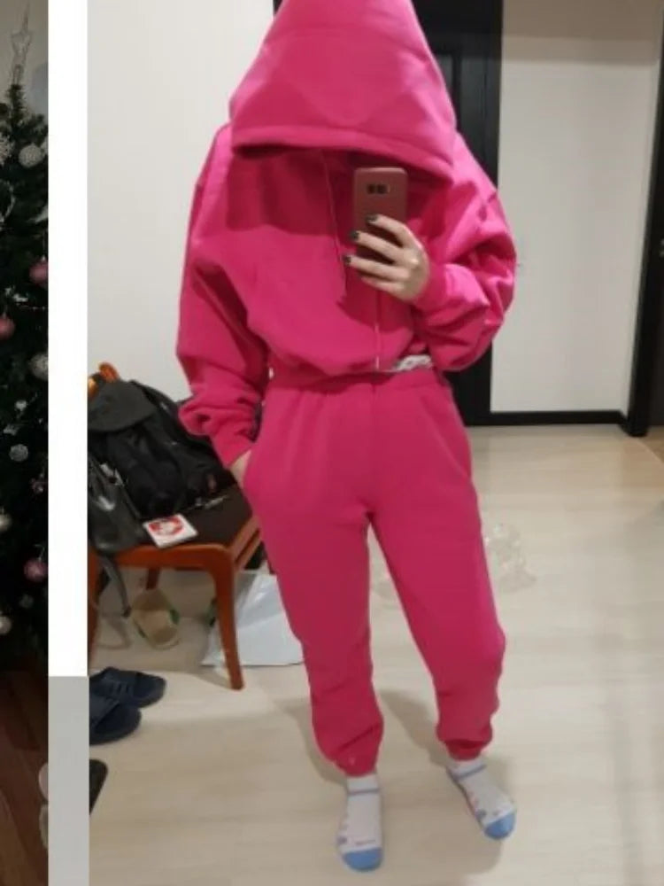 Women's pink hooded fleece tracksuit set with full sleeves and ankle-length pants, ideal for casual winter and spring wear.