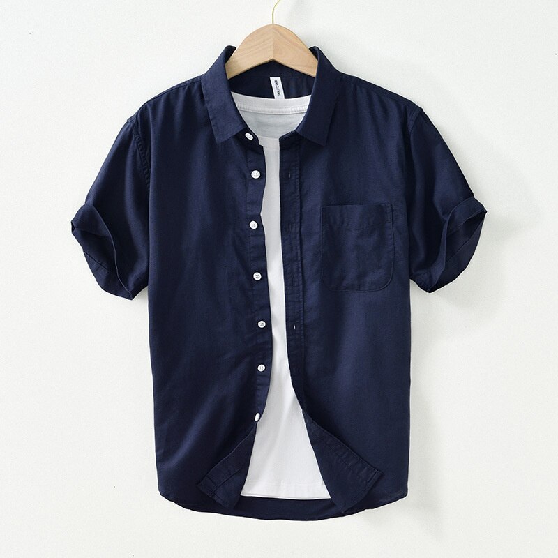 Solid color casual short-sleeved shirt for men in cotton-linen blend, navy, artistic style.