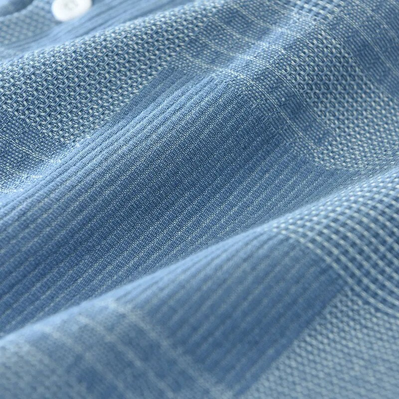 Blue pure cotton fabric texture of men's vintage patch shirt with turn-down collar.