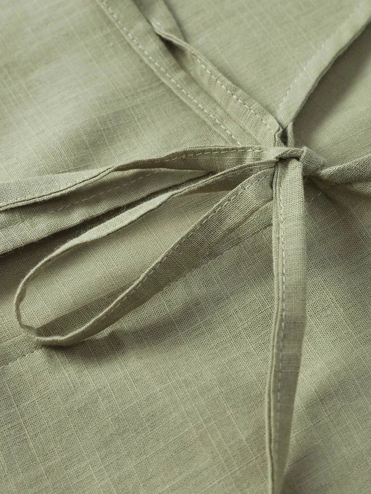 Close-up of lace-up detail on olive green cotton linen shirt with a textured finish, designed for women, featuring a loose fit.