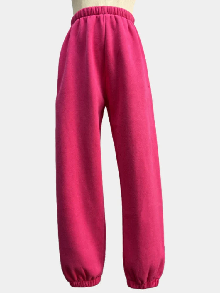 Women's solid pink fleece tracksuit sweatpants, ankle-length with elastic waist.