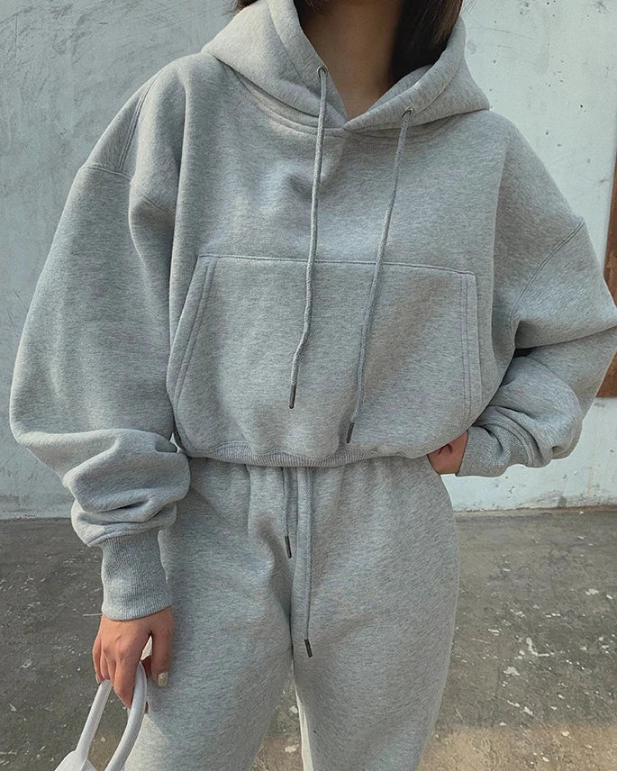 Women's casual solid gray fleece tracksuit, hooded sweatshirt with drawstrings, and ankle-length sweatpants for winter or spring.