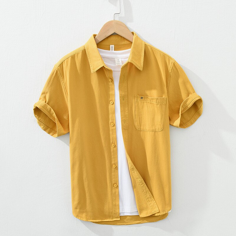 Yellow short sleeve cotton shirt for men with button-up design and patch pocket, casual summer fashion.