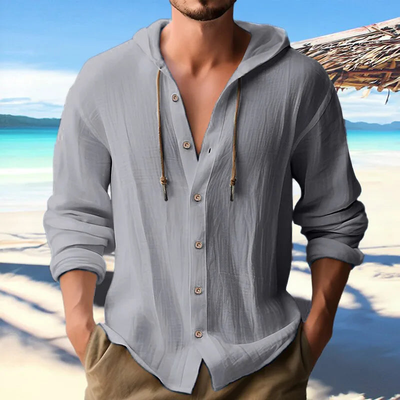 Men's linen long sleeve hooded shirt with buttons, casual streetwear style, beach background.