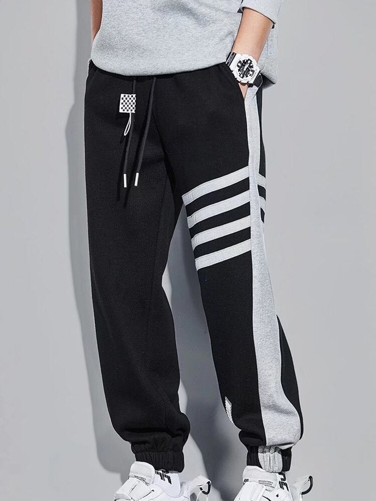 URSPORTTECH techwear hip hop joggers, black with gray stripe detailing, elastic waist, streetwear casual style for men.