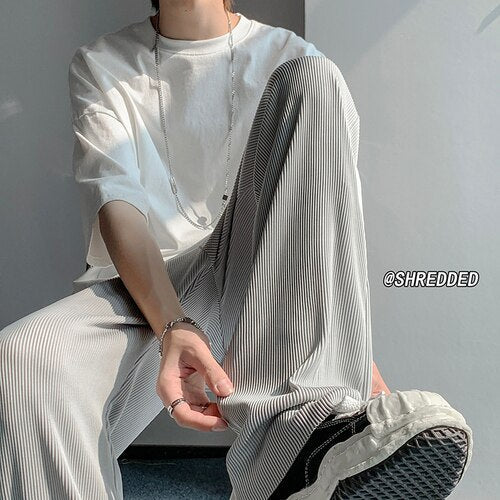 Men's casual loose wide-leg summer pants with elastic waist and striped design.