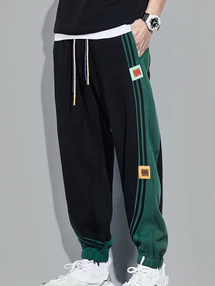 URSPORTTECH black and green joggers with elastic waist, drawstring, and side stripes, streetwear hip hop style.