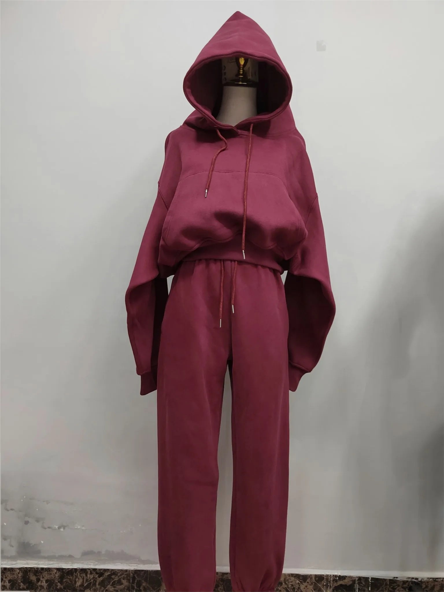 Women's fleece tracksuit set with hooded sweatshirt and sweatpants in solid color. Suitable for winter and spring casual wear.