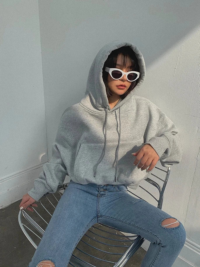 Women's casual grey hoodie with ripped jeans, showcasing the Hoodies Suit Winter Spring Solid Casual Tracksuit with fleece material for comfort and style.