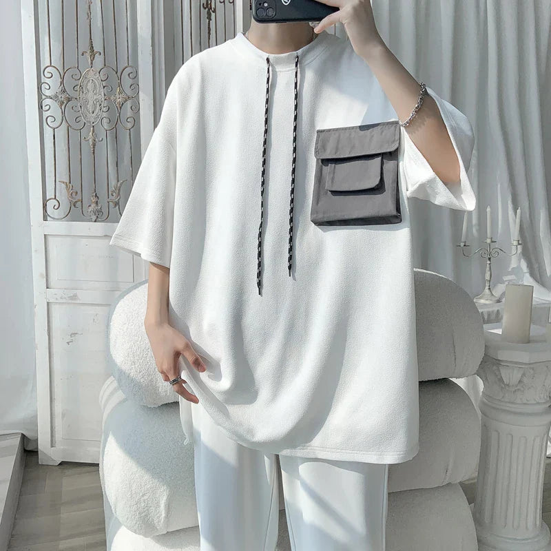 LAPPSTER Y2k Streetwear oversized white t-shirt with black cargo pocket, Harajuku fashion, summer 2023.