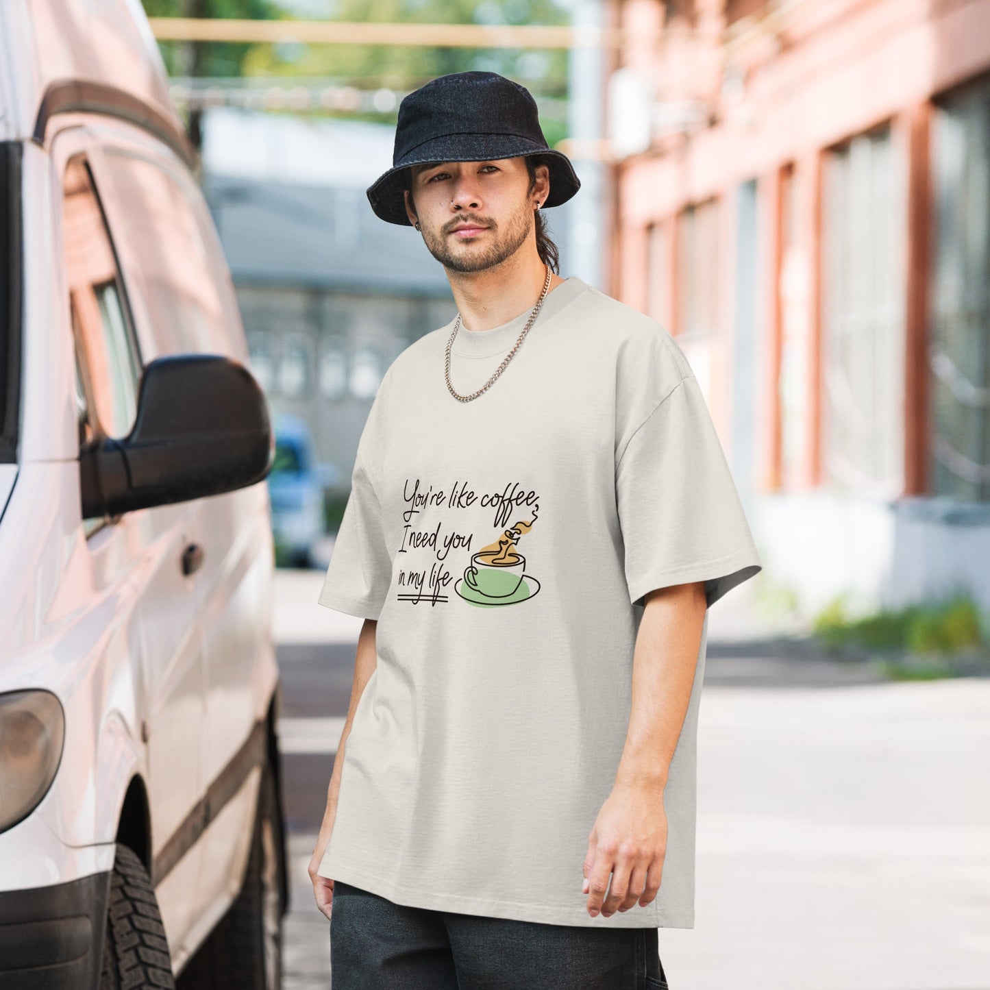 Oversized faded t-shirt with a coffee graphic, 100% carded cotton, worn by a male model.