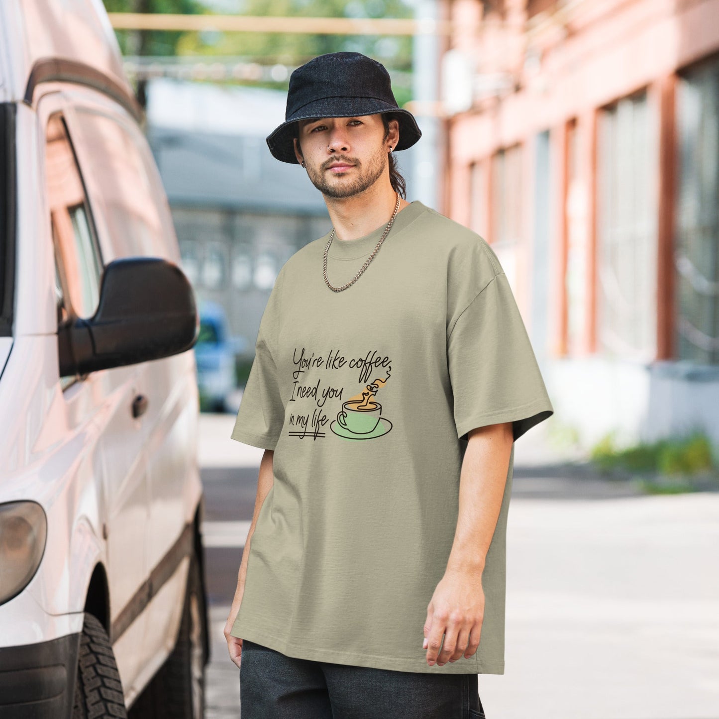 Oversized faded t-shirt with coffee design, 100% cotton, boxy fit, worn by man.